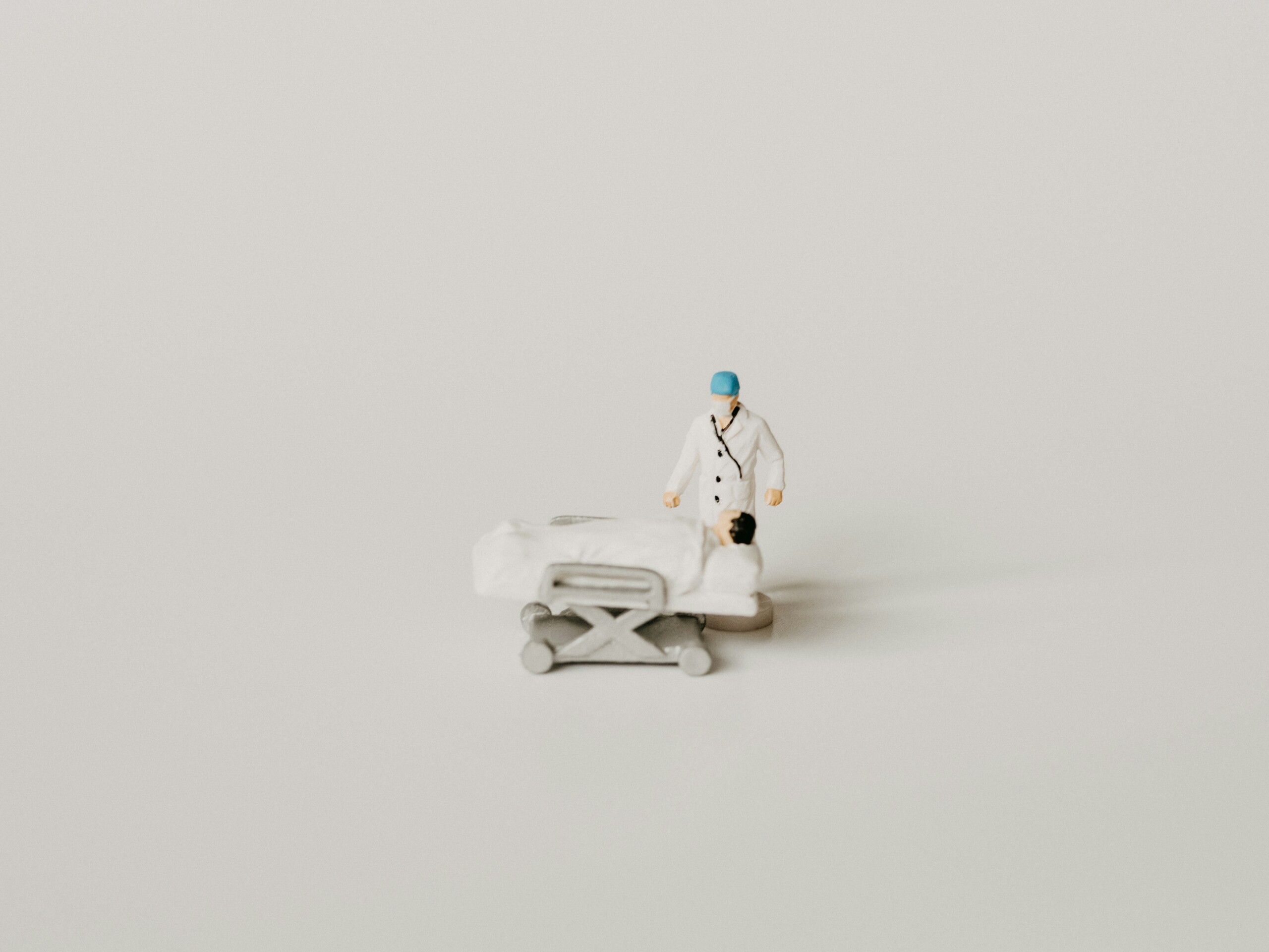 a model of a miniature doctor and patient on a gurney